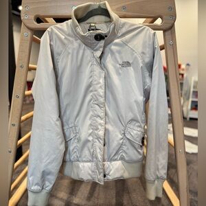 The North Face Women's Cream bomber jacket with hook button at neck and pockets